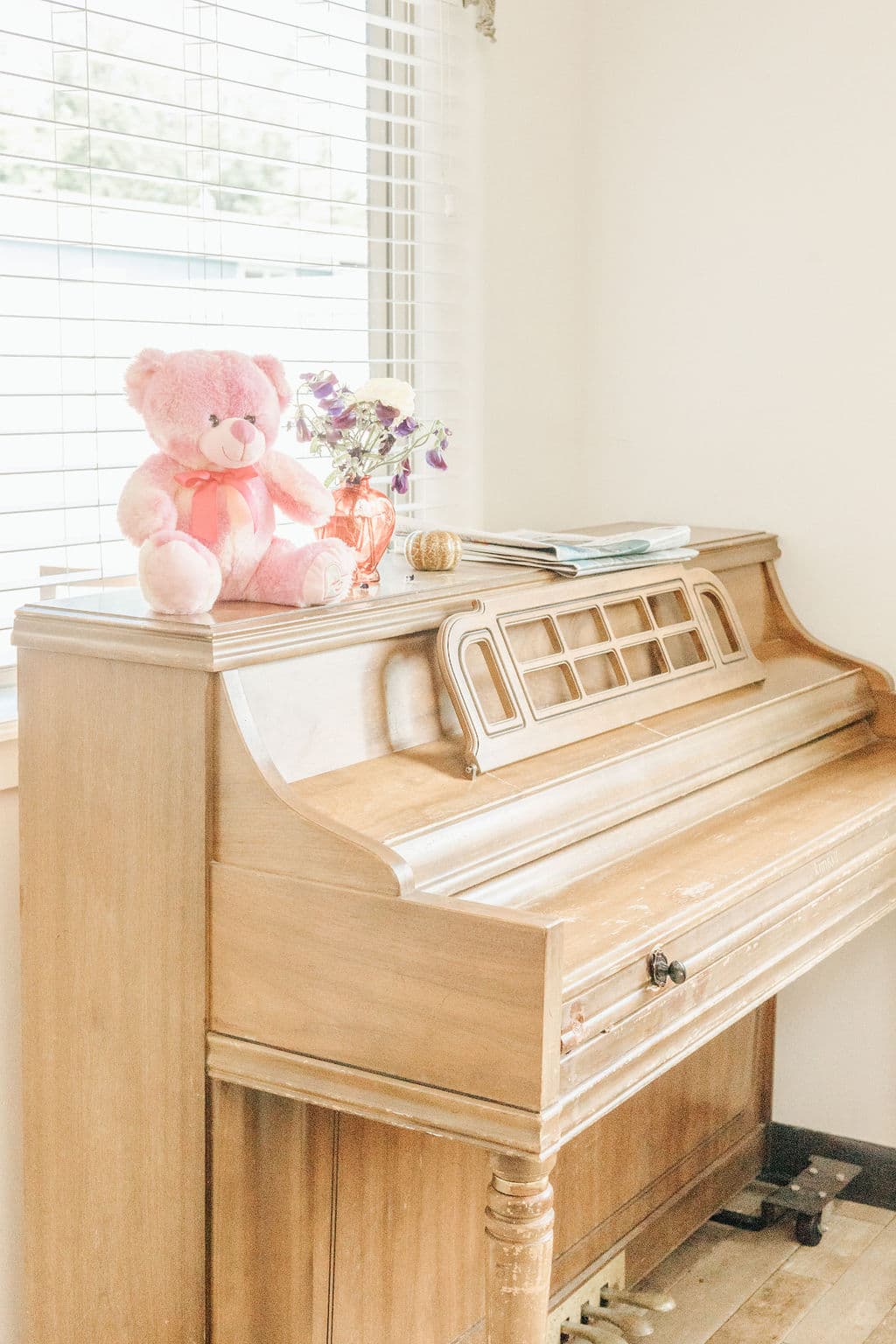 Upright piano beside a sunlit window at Redwood Park