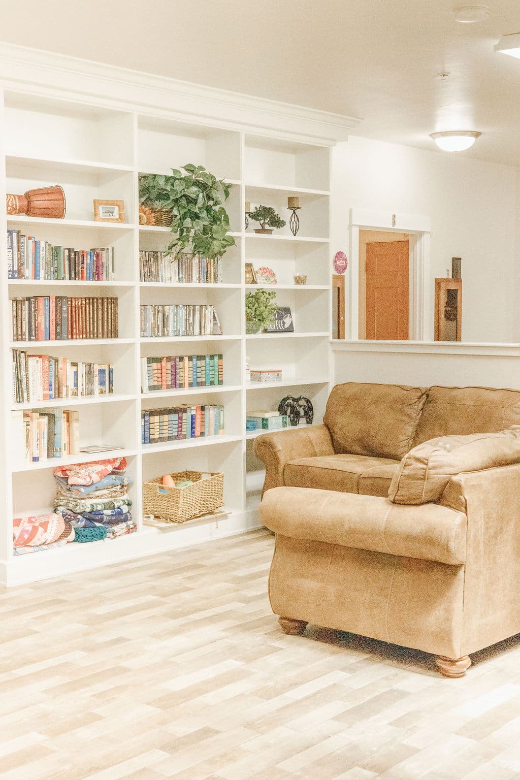 Library corner at Redwood Park with floor-to-ceiling bookshelves and a cushioned sofa
