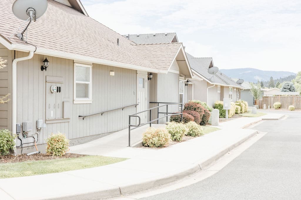 The row of cottages at Kinsington Place in Grants Pass, with the Southern Oregon hills rising at the end of the street